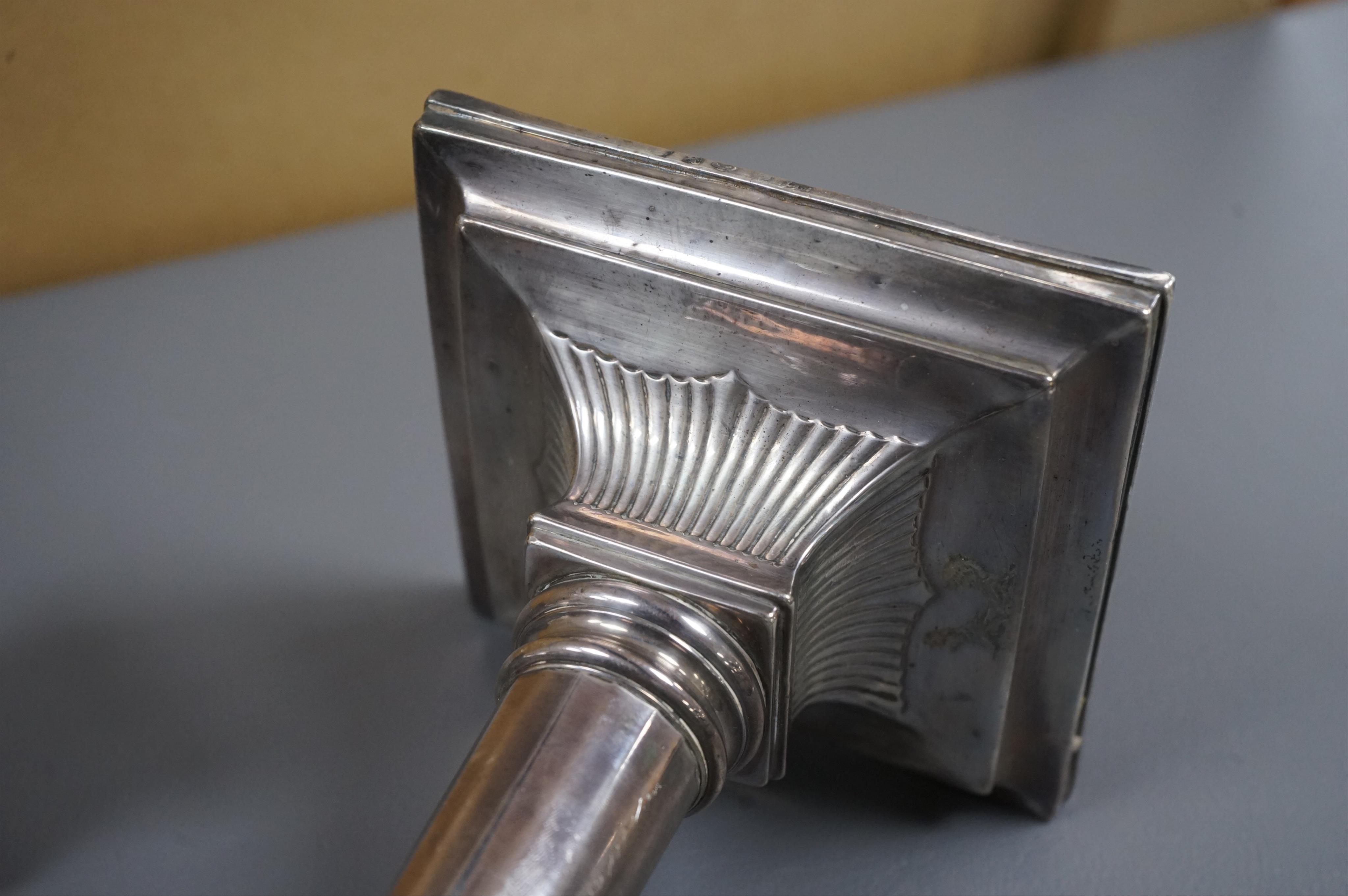 A pair of George III silver candlesticks by Luke Proctor & Co, with panelled stems(worn), on square bases with two engraved armorials, Sheffield, 1786, height 17.4cm, weighted (a.f.).